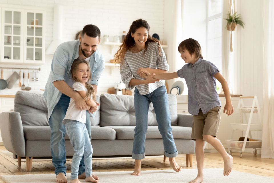 Family dancing together in their living room